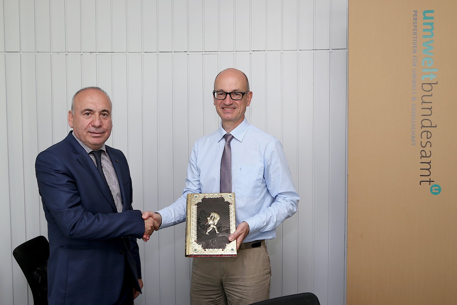 Deputy Minister Solomon Pavliashvili presents Environment Agency Austria Managing Director Georg Rebernig with a book by famous Georgian writer Shota Rustaveli